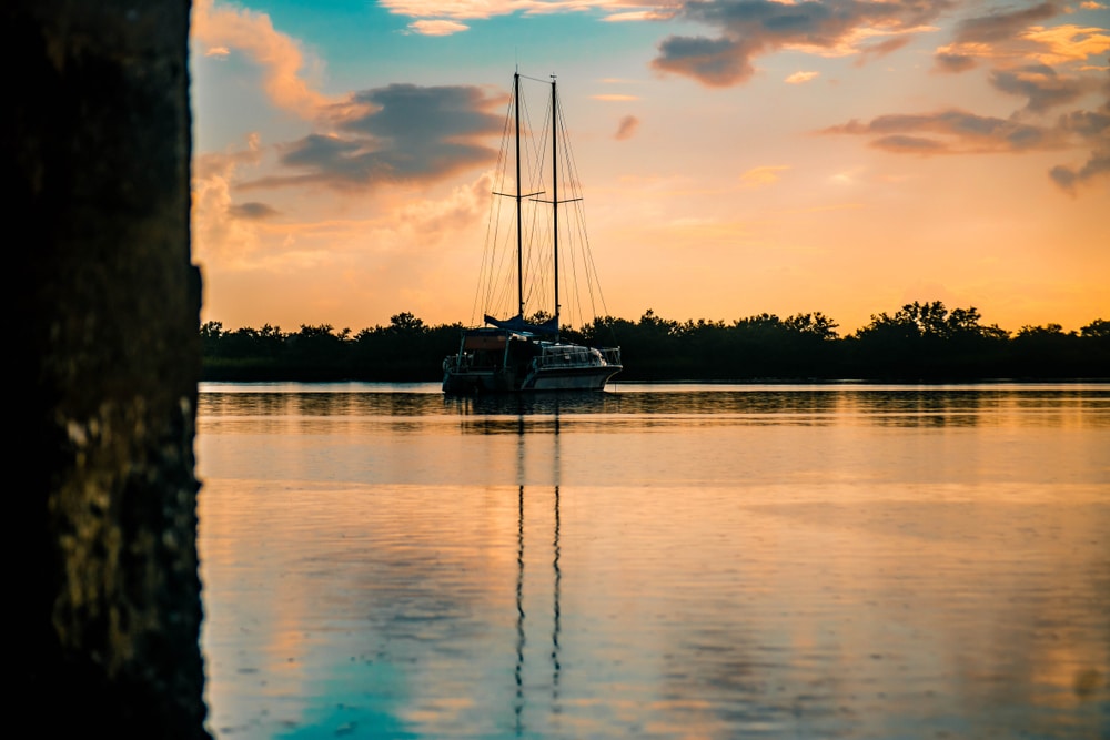 Sunrise over the Intracoastal Waterway in Florida with sail boat in background,
